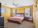 Spacious bedroom featuring a ceiling fan, carpet, and multiple windows for natural light at 10010 W Illini St, Tolleson, AZ 85353