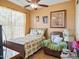 Cozy bedroom featuring a comfortable bed, armchair, ceiling fan, and plenty of natural light at 10010 W Illini St, Tolleson, AZ 85353
