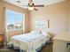 Bright bedroom featuring a bed with a decorative quilt and plenty of natural light at 10010 W Illini St, Tolleson, AZ 85353