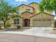 Charming two-story stucco home with a well-manicured front yard and attached two car garage at 10010 W Illini St, Tolleson, AZ 85353