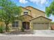 Charming two-story stucco home with a well-manicured front yard and attached two car garage at 10010 W Illini St, Tolleson, AZ 85353