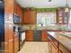 Well-equipped kitchen showcasing ample cabinet space, modern appliances, and a charming window view at 10010 W Illini St, Tolleson, AZ 85353