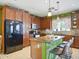Spacious kitchen featuring stainless steel appliances, granite countertops, and a center island with seating at 10010 W Illini St, Tolleson, AZ 85353