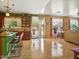 Open layout with kitchen island, tile floors, and sliding doors to the outdoor space at 10010 W Illini St, Tolleson, AZ 85353