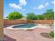 Backyard pool with red brick patio and privacy wall, creating a relaxing outdoor oasis at 10010 W Illini St, Tolleson, AZ 85353