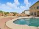 Large backyard with a private swimming pool, patio area, and desert landscaping at 10010 W Illini St, Tolleson, AZ 85353
