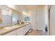 Bright bathroom featuring double sinks with white cabinets and tile flooring at 10440 W Swayback Pass, Peoria, AZ 85383