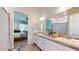 Bright bathroom featuring double sinks with white cabinets and tile flooring at 10440 W Swayback Pass, Peoria, AZ 85383