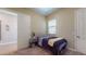 Relaxing bedroom with natural light, neutral walls, and a sliding door for added privacy and convenience at 10440 W Swayback Pass, Peoria, AZ 85383