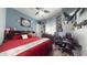 Comfortable bedroom featuring vibrant colors, an entertainment center, and a well-lit study area at 10440 W Swayback Pass, Peoria, AZ 85383
