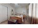 Comfortable bedroom featuring a wooden bed frame, bedside tables, and a large window with curtains at 10440 W Swayback Pass, Peoria, AZ 85383