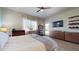 Well-lit bedroom with a ceiling fan, and sliding glass door access to the backyard and pool area at 10440 W Swayback Pass, Peoria, AZ 85383