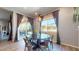 An open dining area featuring a stylish pendant light and sliding glass doors to the patio at 10440 W Swayback Pass, Peoria, AZ 85383