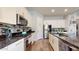 Modern kitchen with granite countertops, stainless steel appliances, and white cabinets at 10440 W Swayback Pass, Peoria, AZ 85383