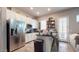 Modern kitchen featuring stainless steel appliances and an island with bar seating at 10440 W Swayback Pass, Peoria, AZ 85383