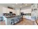 Bright kitchen featuring white cabinets, granite countertops, and a breakfast bar at 10440 W Swayback Pass, Peoria, AZ 85383