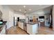 This spacious kitchen features an island and stainless steel appliances, seamlessly flowing into the living room at 10440 W Swayback Pass, Peoria, AZ 85383
