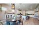 Spacious open-concept kitchen and dining area with modern lighting and finishes at 10440 W Swayback Pass, Peoria, AZ 85383