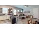 Open-concept living space with a kitchen island, tile flooring, and plentiful natural light from large windows at 10440 W Swayback Pass, Peoria, AZ 85383
