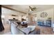 This open-concept living room features a ceiling fan and transitions seamlessly into the kitchen at 10440 W Swayback Pass, Peoria, AZ 85383