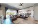 Open-concept living space with tile floors, a large sectional sofa, and natural light at 10440 W Swayback Pass, Peoria, AZ 85383