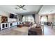 Comfortable living room featuring tile floors, neutral colors, and backyard views at 10440 W Swayback Pass, Peoria, AZ 85383