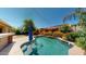Backyard pool with a built-in bar and lush green surroundings perfect for outdoor relaxation at 10440 W Swayback Pass, Peoria, AZ 85383