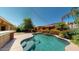 Lush backyard with a pristine pool, charming landscaping, and delightful string lights at 10440 W Swayback Pass, Peoria, AZ 85383