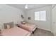 Bedroom featuring twin beds, a ceiling fan, and a window providing plenty of natural light at 1066 E Pueblo Rd, Phoenix, AZ 85020