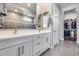 Bathroom featuring dual sinks, framed mirrors, and views to the walk-in closet and tiled shower at 1202 E Nolan Pl, Chandler, AZ 85249