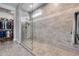 Bright bathroom featuring a tiled glass shower with a view of the walk-in closet at 1202 E Nolan Pl, Chandler, AZ 85249
