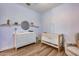 Bedroom featuring a crib, changing table, glider chair, and decorative shelves at 1202 E Nolan Pl, Chandler, AZ 85249