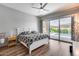 Bedroom with ceiling fan and sliding glass doors providing ample natural light and backyard pool views at 1202 E Nolan Pl, Chandler, AZ 85249