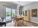 Dining area with wood table, sliding glass doors, and pool view at 1202 E Nolan Pl, Chandler, AZ 85249
