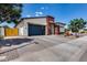 Front of the home features a two-car garage, brick driveway, and desert landscaping at 1202 E Nolan Pl, Chandler, AZ 85249