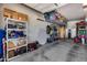 Spacious garage with ample storage solutions, including shelving and overhead racks for organization at 1202 E Nolan Pl, Chandler, AZ 85249