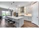 Open kitchen featuring white cabinets, quartz countertops, island with seating, and stainless steel appliances at 1202 E Nolan Pl, Chandler, AZ 85249
