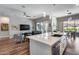 Kitchen featuring an island with barstool seating, stainless steel appliances, and an open concept to the living room at 1202 E Nolan Pl, Chandler, AZ 85249