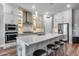 Modern kitchen features an island with barstool seating, stainless steel appliances, and modern cabinets at 1202 E Nolan Pl, Chandler, AZ 85249