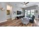 Open-concept living room featuring wood flooring, ceiling fan, and sliding glass doors leading to the backyard at 1202 E Nolan Pl, Chandler, AZ 85249