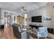 Open concept living room featuring wood floors, a TV, and neutral furniture at 1202 E Nolan Pl, Chandler, AZ 85249