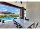 Inviting covered patio featuring a dining table with seating and a view of the sparkling pool at 1202 E Nolan Pl, Chandler, AZ 85249