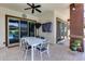 Covered patio with outdoor dining set, ceiling fan, and sliding glass doors at 1202 E Nolan Pl, Chandler, AZ 85249