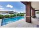 Beautiful pool with a waterfall feature surrounded by lush landscaping and patio area at 1202 E Nolan Pl, Chandler, AZ 85249