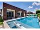 Backyard pool featuring a tanning ledge, lounge chairs, and covered patio with outdoor seating at 1202 E Nolan Pl, Chandler, AZ 85249