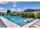 Beautiful pool features in-pool lounge chairs, lush landscaping, and serene water features at 1202 E Nolan Pl, Chandler, AZ 85249