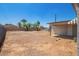 Spacious backyard with gravel, fencing, and mature trees at 122 N 5Th St, Avondale, AZ 85323