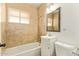 Cozy bathroom featuring neutral tile in the shower and on the floors and a white vanity at 122 N 5Th St, Avondale, AZ 85323