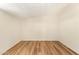 Empty neutral bedroom with a single window offering natural light, featuring wood-look flooring at 122 N 5Th St, Avondale, AZ 85323
