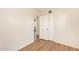 Neutral bedroom with a doorway, featuring wood-look flooring and neutral wall paint at 122 N 5Th St, Avondale, AZ 85323